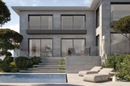 Pool terrace facing the two-story stone and glass villa