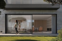 Floor-to-ceiling living room glazing opening onto the lawn